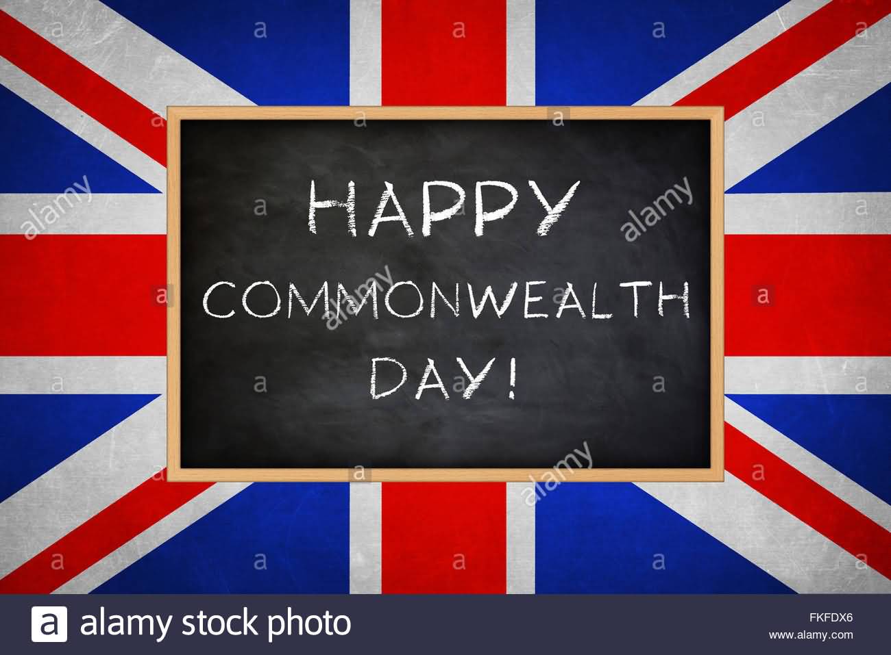 Happy Commonwealth Day Written With Chalk On Black Board With Union Flag In Background