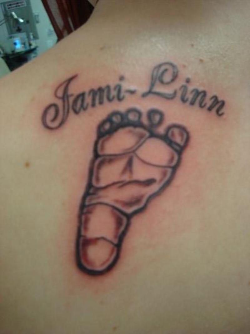 Jami Linn - Black Ink Foot Print Tattoo On Upper Back