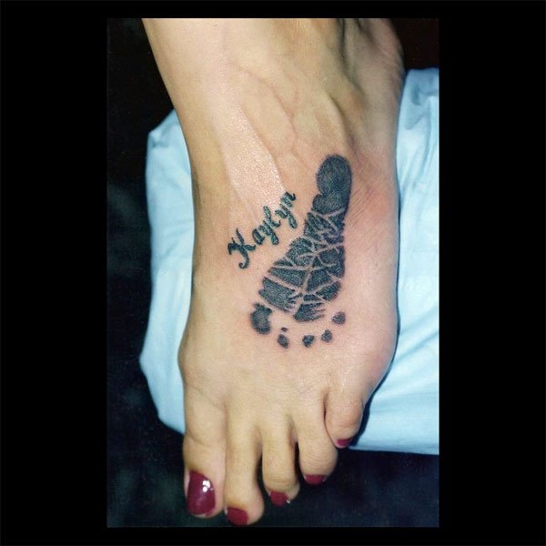 Kaylyn - Black Ink Foot Print Tattoo On Women Left Foot