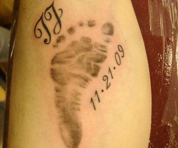 Memorial Black Ink Footprint Tattoo Design For Leg Calf