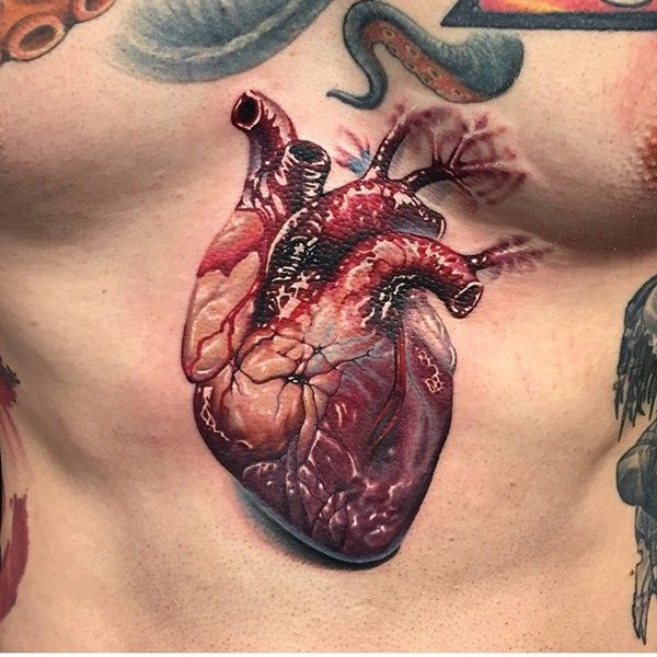 Realistic Real Heart Tattoo On Man Chest