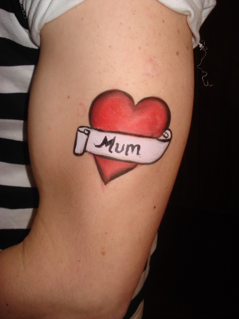 Red Ink Heart With Mum Banner Tattoo On Left Half Sleeve