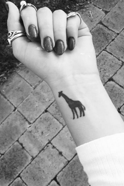 Silhouette Giraffe Tattoo On Girl Left Wrist