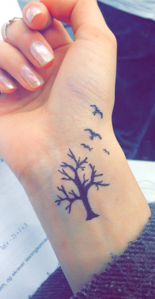Silhouette Tree Without Leaves And Flying Birds Tattoo On Girl Right Wrist