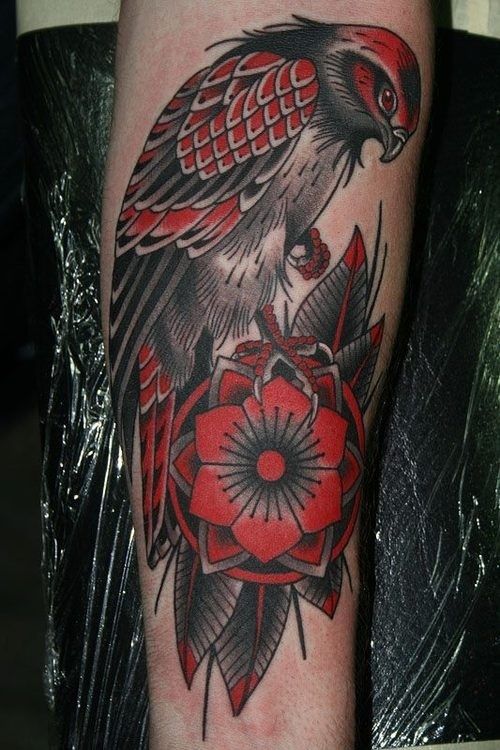 Traditional Black And Red Hawk With Flower Tattoo On Forearm