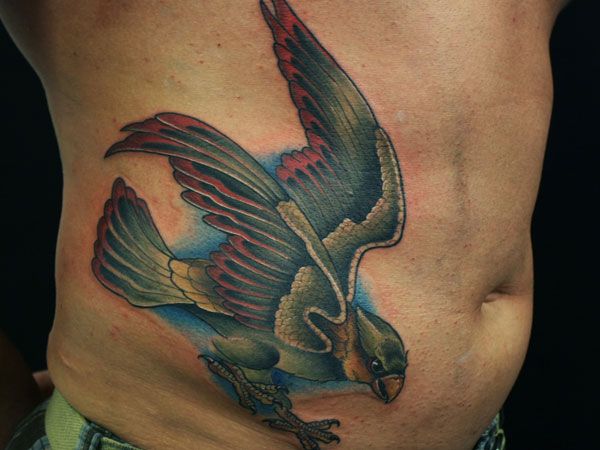 Traditional Flying Hawk Tattoo On Man Right Side Rib