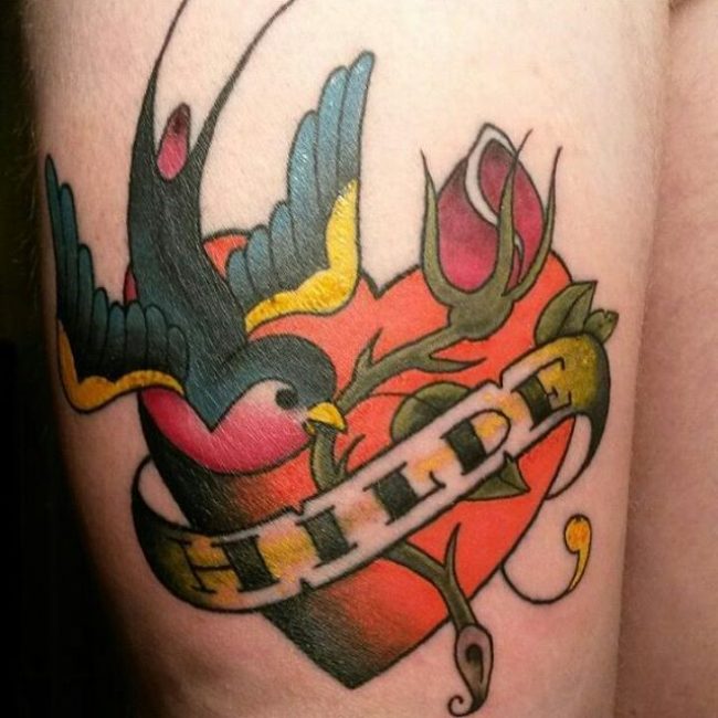 Traditional Heart With Banner And Flying Bird Tattoo On Thigh