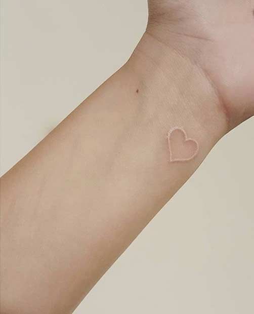 White Ink Heart Tattoo On Left Wrist