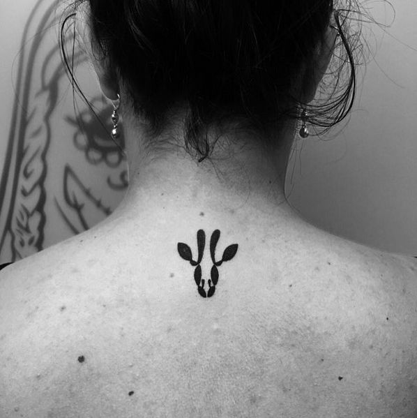 Wonderful Black Giraffe Head Tattoo On Women Upper Back