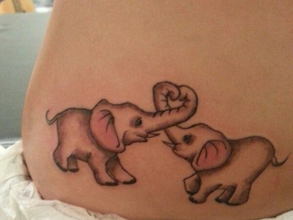 Baby Elephants Playing And Making Hearts With Trunks Tattooed On Lower Back