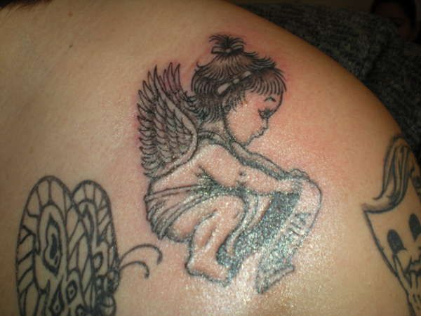 Baby angel tattoo with ribbon on back shoulder