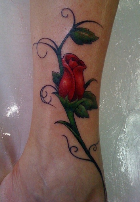 Beautiful Rose Bud And Tribal Stick Tattoo On Leg