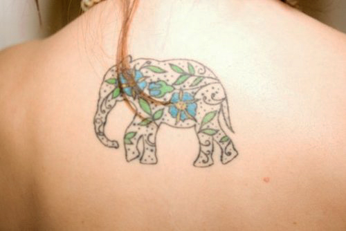 Blue Flower In Elephant Tattoo On Upper Back