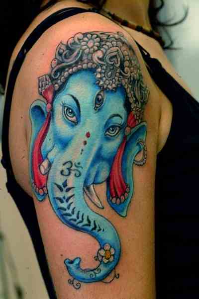 Colorful Lord Ganesha Head Tattoo On Right Shoulder