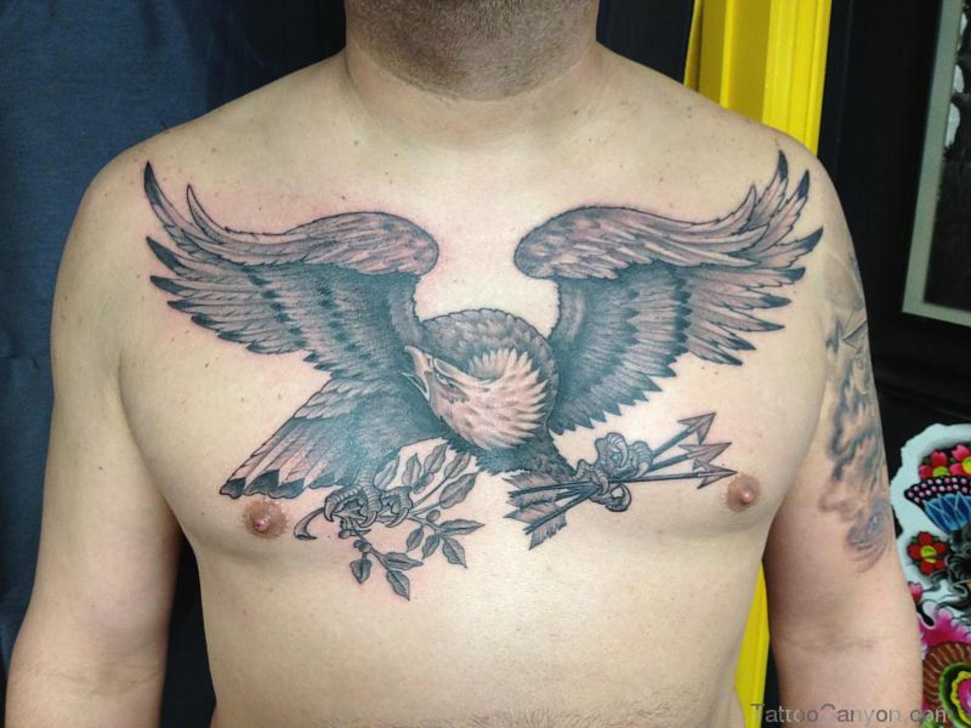 Grey Ink Flying Eagle With Arrows and Plant In Claws Tattoo On Chest