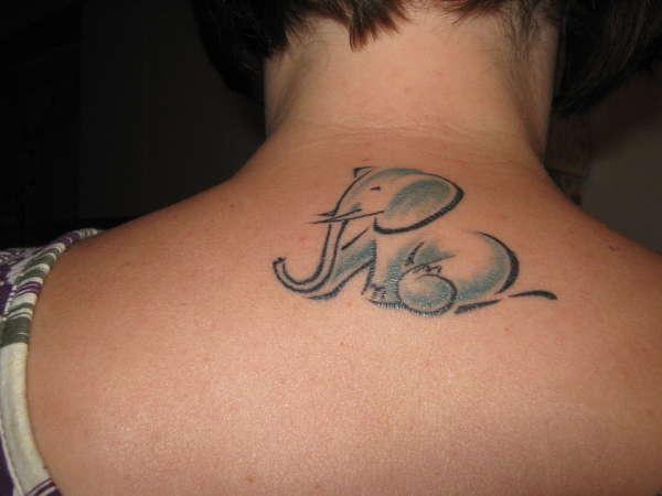 Light Blue Baby Elephant Tattoo On Upper Back