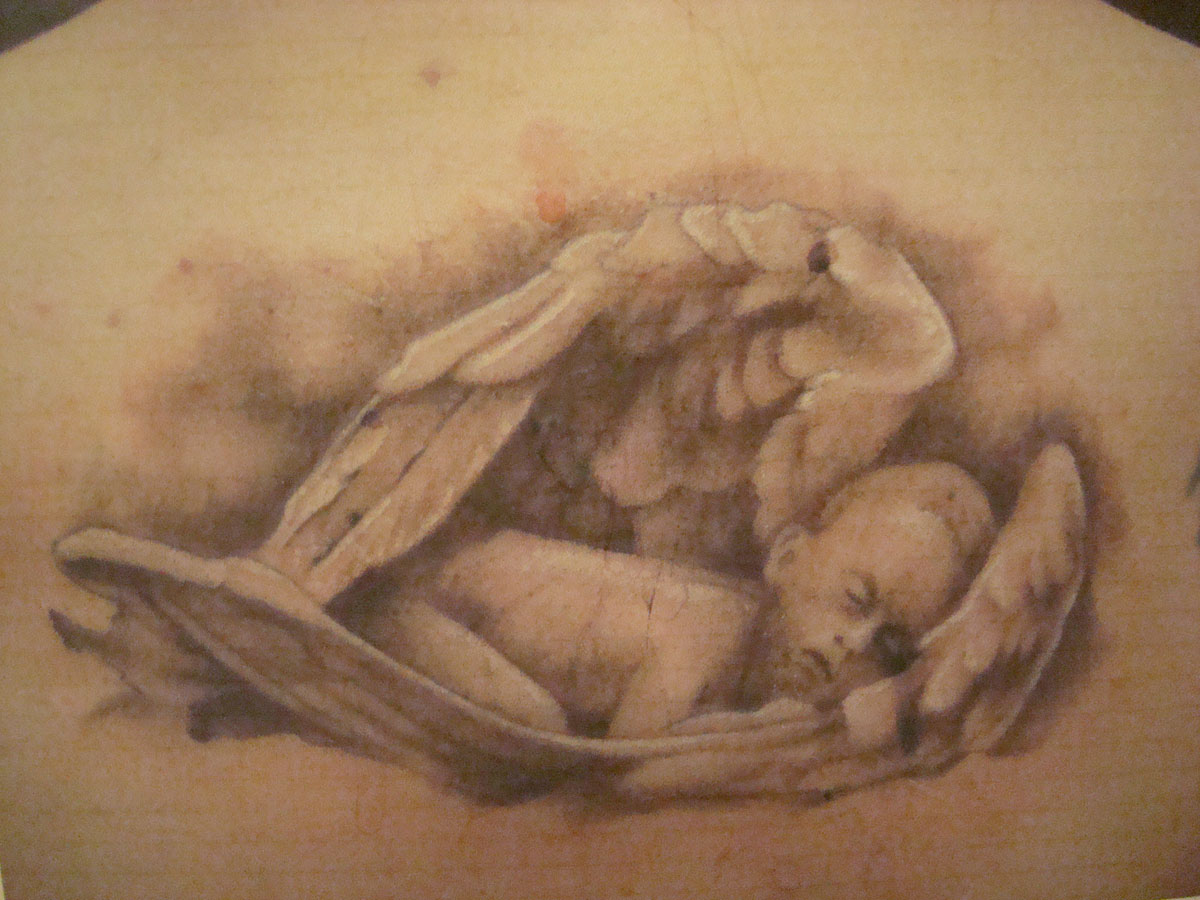 Memorial baby angel sleeping in wings tattoo design
