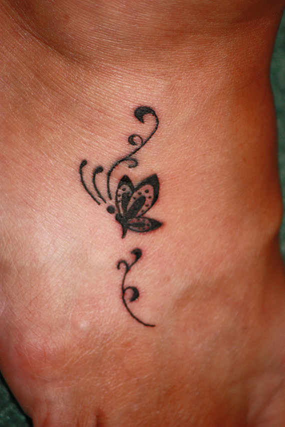 Nice Black Flying Butterfly Tattoo On Right Foot