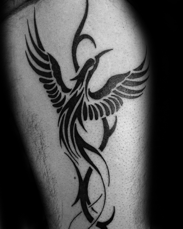 Nice Black Ink Tribal And Flying Phoenix Tattoo Design