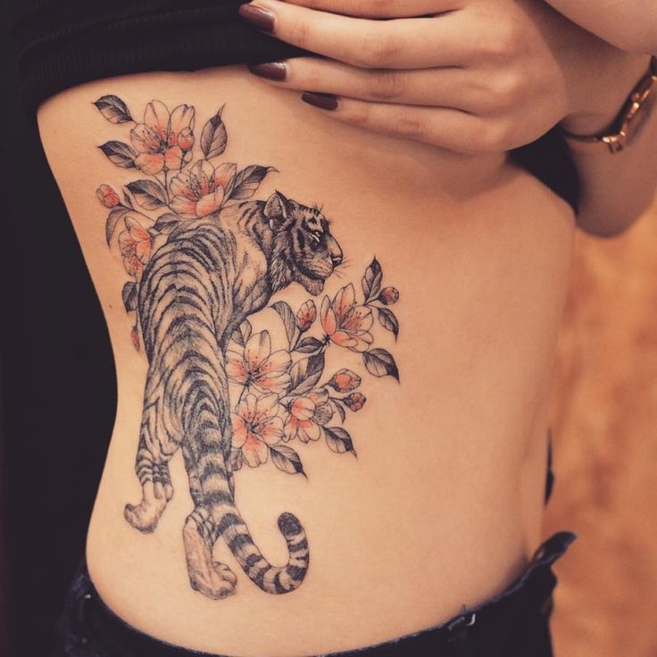 Nice Flowers And Tiger Tattoo On Girl Side rib