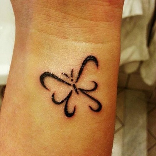 Outline Swirl Butterfly Tattoo On Left Wrist