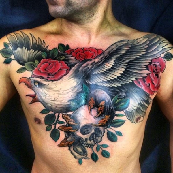 Red Flowers And Flying Eagle With Skull In Claws Tattoo On Chest