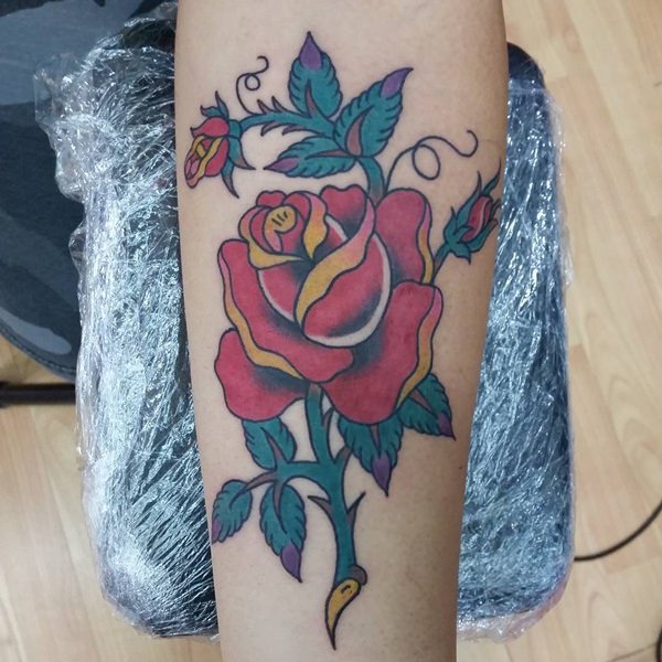Red Rose And Green Leaves Tattoo On Forearm