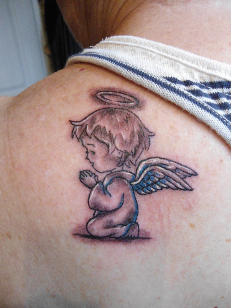 Small praying baby angel with holy ring tattoo on left back shoulder