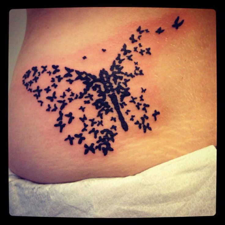 Tiny Black Butterflies Made A Big Butterfly Tattoo On Lower Back