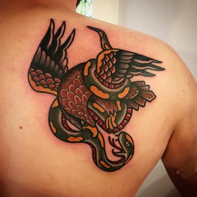 Traditional Eagle And Snake Fighting Tattoo On Back