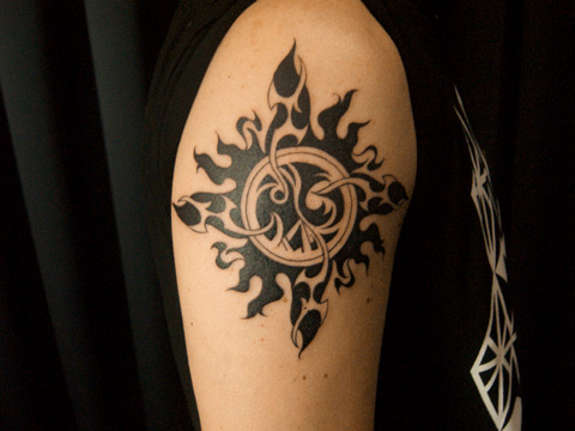 Awesome Black Tribal Sun Tattoo On Shoulder