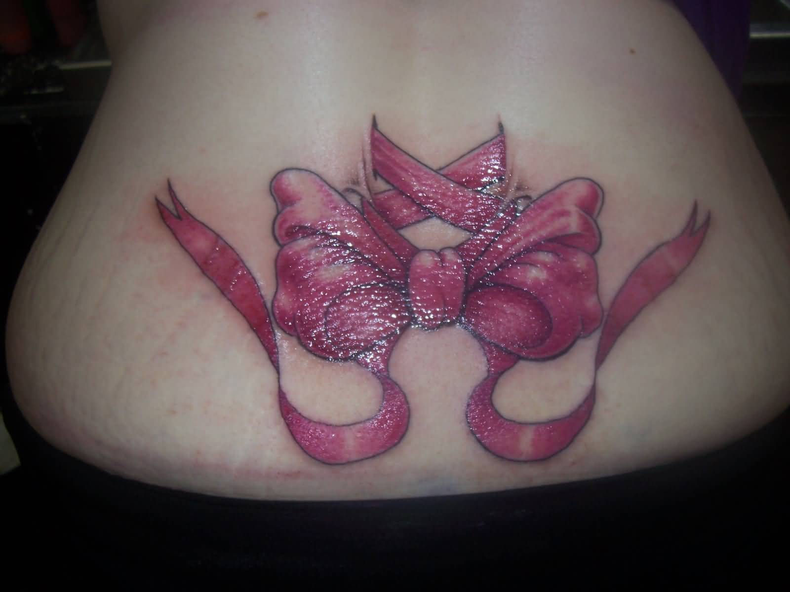Beautiful Pink Bow Tattoo On Girl Lower Back