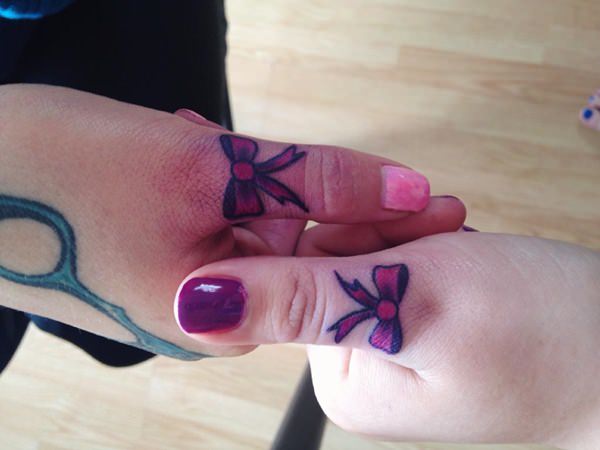 Beautiful Pink Bow Tattoos On Both Thumbs