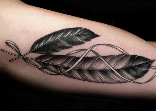 Black And Grey Feather Tattoo On Bicep
