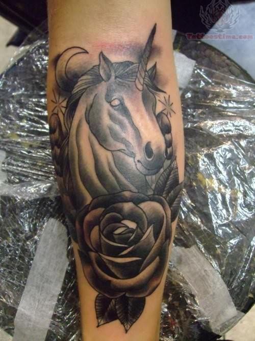 Black And Grey Rose With Gothic Unicorn Head Tattoo On Arm.