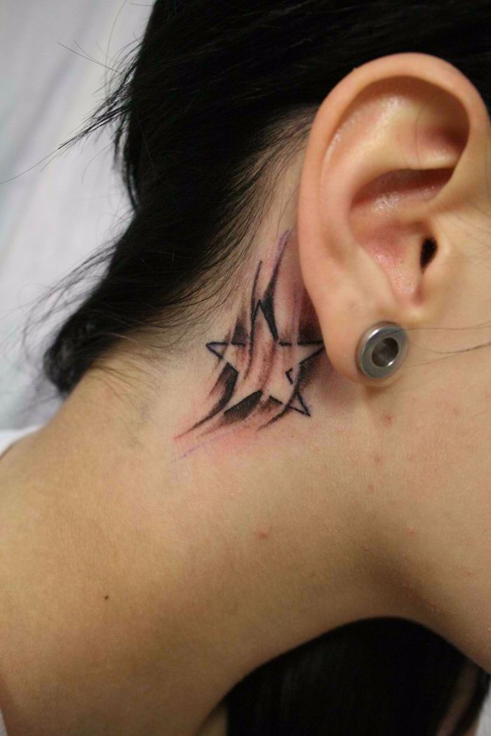 Black And Grey Shooting Stars Tattoo Behind The Ear