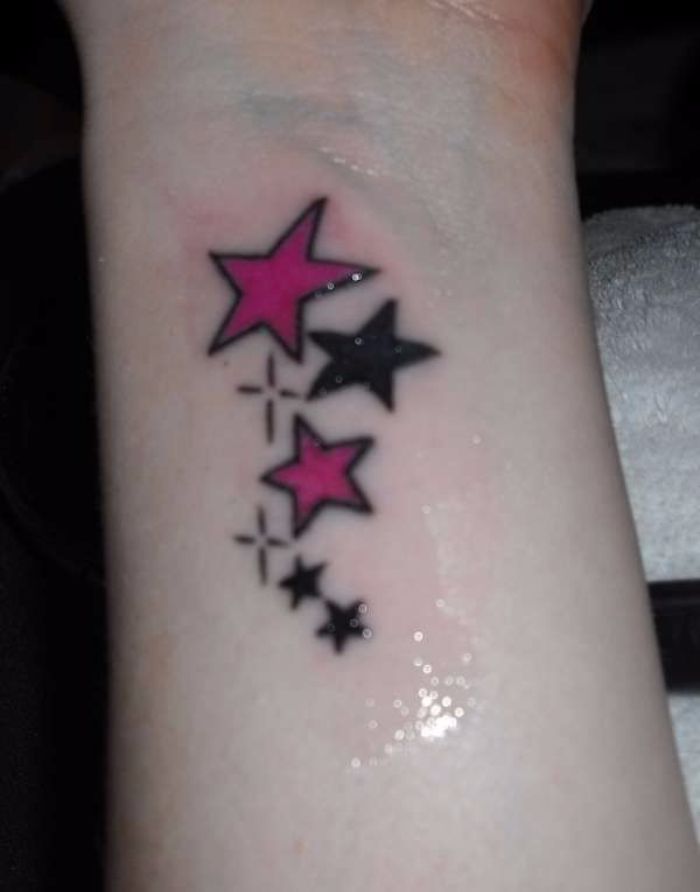Black And Pink Shooting Stars Tattoo On Right Wrist
