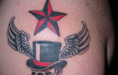 Black And Red Nautical Star Tattoo On Man Shoulder
