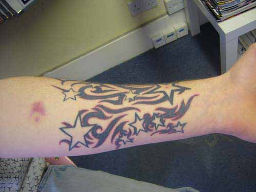 Black And Red Tribal Star Tattoos On Left Forearm