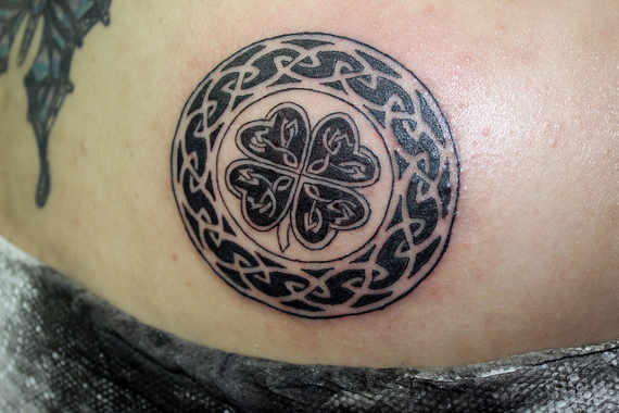 Black Ink Celtic Shamrock Tattoo On Back Shoulder