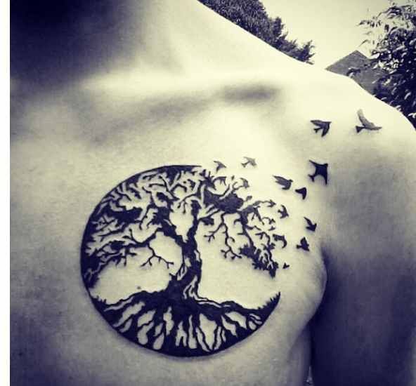 Black Ink Flying Birds From Tree Tattoo On Man Chest