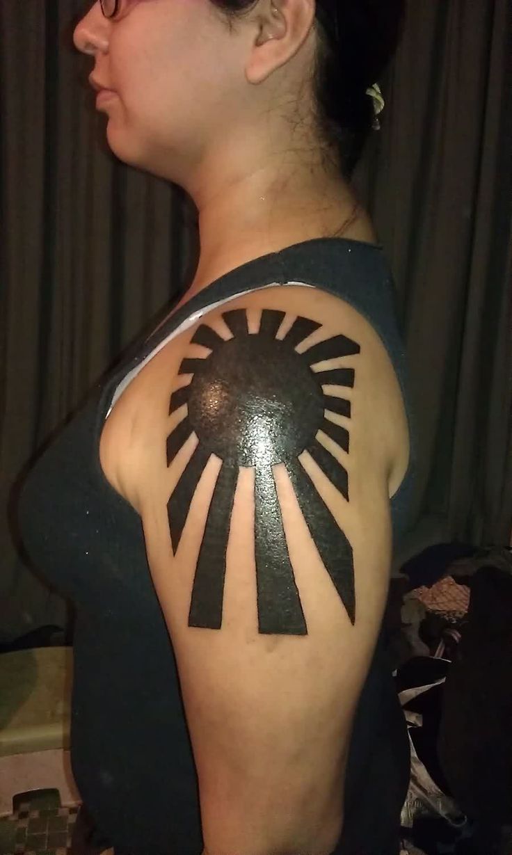 Black Ink Sun Tattoo On Left Shoulder For Women