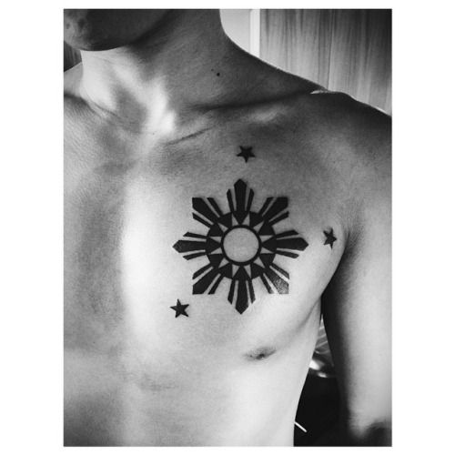 Black Ink Three Stars And Sun Tattoo On Man Chest