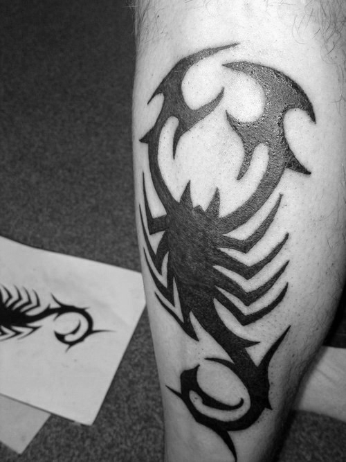 Black Silhouette Tribal Scorpion Tattoo On Back Leg