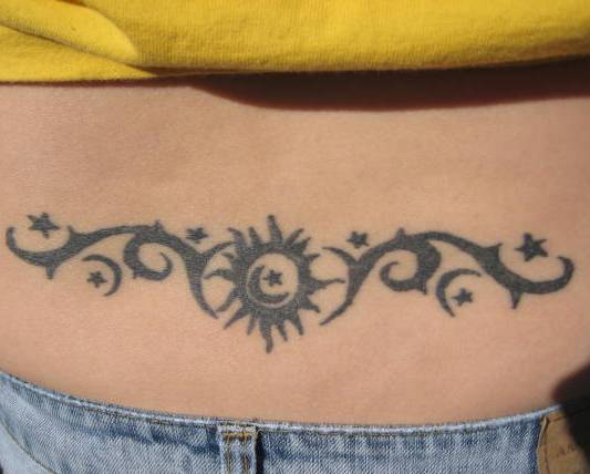 Black Tribal And Sun With Star Tattoo On Lower Back