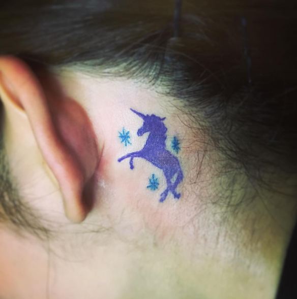 Blue Stars And Feminine Unicorn Tattoo Behind The Ear