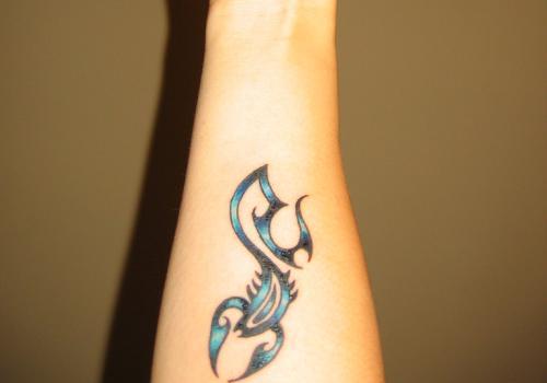 Blue and Black Tribal Scorpion Tattoo On Arm