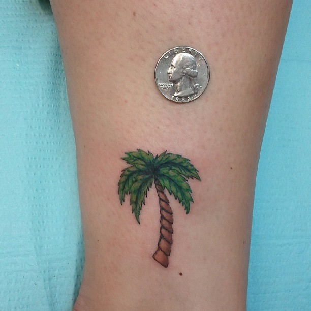 Brown And Green Palm Tree Tattoo On Left Leg