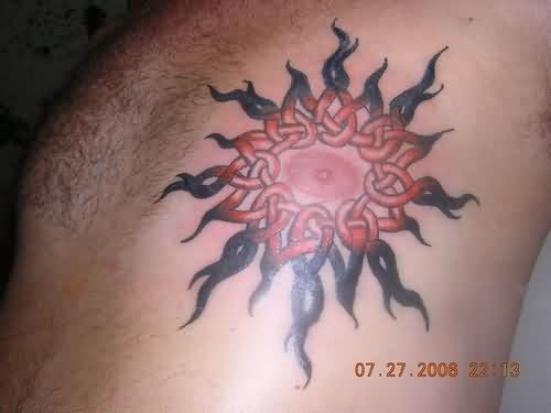 Celtic Sun Tattoo On Man Side Rib