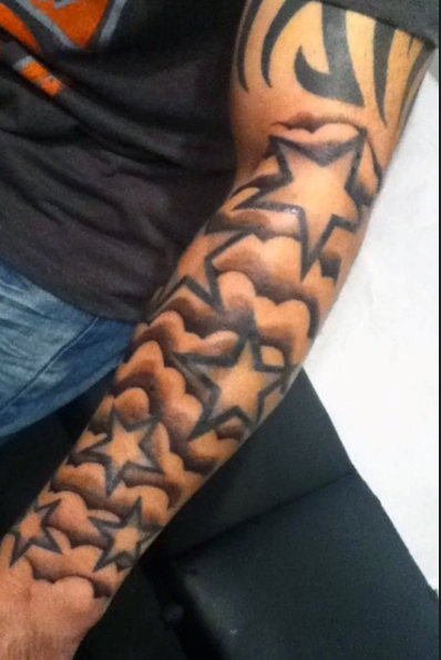Clouds And Outline Star Tattoos On Man Left Sleeve